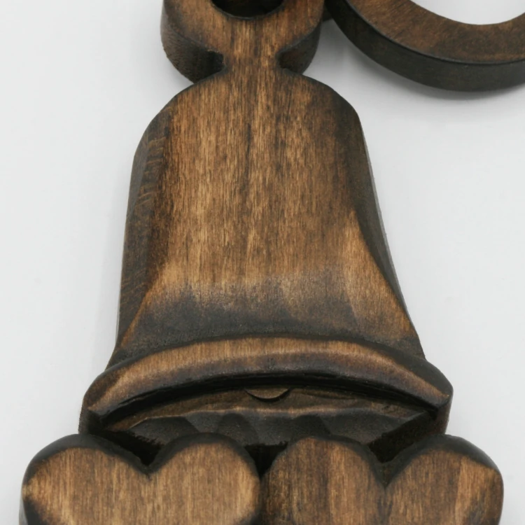 An image of a lovespoon with a symbol of a(n) Bell.