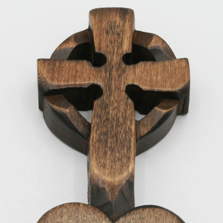 An image of a lovespoon with a symbol of a(n) Cross.