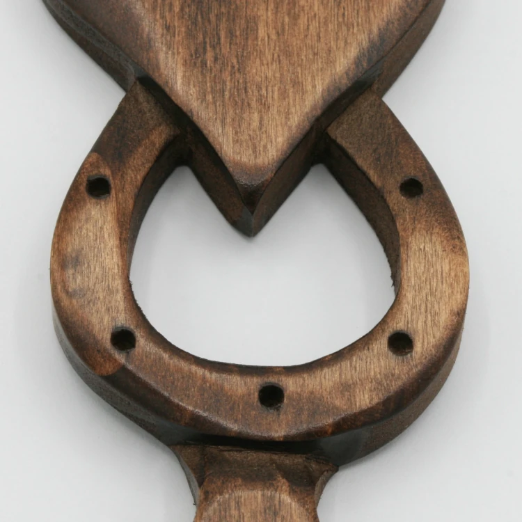 An image of a lovespoon with a symbol of a(n) Horseshoe.